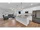 Modern kitchen with stainless steel appliances, granite countertops, a breakfast bar, and hardwood floors at 286 Beacon Hill Rd, Lillington, NC 27546