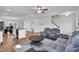 Open-concept living room with hardwood floors, modern furnishings, and a seamless flow into the kitchen at 286 Beacon Hill Rd, Lillington, NC 27546