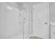 A bright bathroom displays a frameless glass shower enclosure with a rainfall shower head and sleek fixtures at 286 Beacon Hill Rd, Lillington, NC 27546