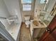 Bathroom featuring a sink, toilet, and shower in need of repair at 306 Martin Luther King Jr Dr, Smithfield, NC 27577