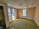 Bedroom featuring a window, light and green carpeting in need of repair at 306 Martin Luther King Jr Dr, Smithfield, NC 27577