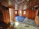 Wood-paneled living room with vintage blue carpet and natural light in need of repair at 306 Martin Luther King Jr Dr, Smithfield, NC 27577