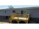 Elevated view of wood deck showing steps down to backyard and door to access to the home at 321 Duke Memorial Road, Louisburg, NC 27549