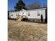 Beautiful single story home boasts gray siding, white trim, and a welcoming entryway at 321 Duke Memorial Road, Louisburg, NC 27549