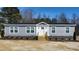 Charming single-story home with gray siding, white trim, and a inviting front entry way at 321 Duke Memorial Road, Louisburg, NC 27549