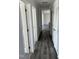 Hallway showcases modern dark flooring, white trim, and multiple doors at 321 Duke Memorial Road, Louisburg, NC 27549