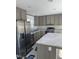 Modern kitchen features gray cabinets, stainless steel appliances, and a marble countertop island at 321 Duke Memorial Road, Louisburg, NC 27549