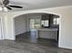 Open layout with arched entry shows the kitchen, stainless steel appliances, and deck access at 321 Duke Memorial Road, Louisburg, NC 27549
