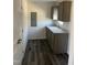 Convenient utility sink area with a white sink and gray shaker cabinets at 321 Duke Memorial Road, Louisburg, NC 27549