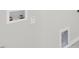 Close-up of basement wall featuring water hookups, electrical outlets, and an access panel at 329 Umstead St, Sanford, NC 27330