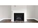 A detailed view of the fireplace showcasing a white mantel and a black firebox at 329 Umstead St, Sanford, NC 27330