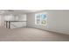 Upstairs hallway with carpet, views of the neighborhood, and a dark railing at 329 Umstead St, Sanford, NC 27330