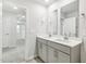 Bathroom features a double sink vanity with gray cabinets and modern fixtures at 3405 Rosebush Dr, Zebulon, NC 27597