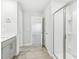 The en-suite bathroom features modern shower, light wood flooring and grey cabinetry at 3405 Rosebush Dr, Zebulon, NC 27597
