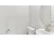 A half bathroom featuring a modern sink, toilet, and fixtures with a circular mirror that complements the decor at 3405 Rosebush Dr, Zebulon, NC 27597