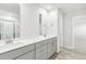 This bathroom features a double sink vanity with quartz countertop and grey cabinetry at 3405 Rosebush Dr, Zebulon, NC 27597