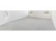 A bedroom with neutral carpeting, two windows and light grey paint is bright and airy at 3405 Rosebush Dr, Zebulon, NC 27597