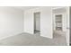 Cozy bedroom with a closet and laundry room view, featuring plush carpet and neutral paint, creating a serene ambiance at 3405 Rosebush Dr, Zebulon, NC 27597