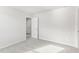 Bright bedroom with plush carpet, white trim, and an open doorway to additional rooms at 3405 Rosebush Dr, Zebulon, NC 27597