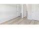 Neutral bedroom features wood-look flooring with several doorways to other rooms and closets; neutral color palette at 3405 Rosebush Dr, Zebulon, NC 27597