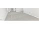 This is a view of a brightly lit hallway with neutral carpeting and light grey walls at 3405 Rosebush Dr, Zebulon, NC 27597