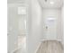 Bright hallway with wood-look flooring, leading to various rooms within the home and a front door with glass at 3405 Rosebush Dr, Zebulon, NC 27597