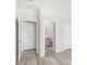 Hallway view showcasing access to a bathroom and bedroom featuring neutral color and consistent flooring throughout the home at 3405 Rosebush Dr, Zebulon, NC 27597