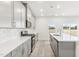 Well-lit kitchen with white countertops, gray cabinets, and stainless steel appliances at 3405 Rosebush Dr, Zebulon, NC 27597