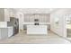 Modern kitchen with stainless steel appliances, gray cabinets, and a large kitchen island at 3405 Rosebush Dr, Zebulon, NC 27597
