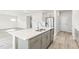Contemporary kitchen island with stainless steel sink, modern faucet, and gray cabinetry at 3405 Rosebush Dr, Zebulon, NC 27597