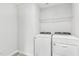 Laundry room features a white washer and dryer, and wire shelving for storage and organization at 3405 Rosebush Dr, Zebulon, NC 27597