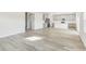 Bright open-concept living space with views of the kitchen and staircase at 3405 Rosebush Dr, Zebulon, NC 27597