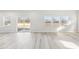 Open living space with large sliding glass doors and many windows overlooking the backyard at 3405 Rosebush Dr, Zebulon, NC 27597
