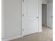 Light-filled bedroom boasts neutral carpet and white door and trim at 36 Sweet Meadow Rd, Angier, NC 27501
