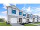 Attractive townhomes with a sleek architectural style, each featuring a garage and landscaping at 36 Sweet Meadow Rd, Angier, NC 27501
