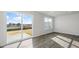 Bright living room featuring plank floors, a sliding glass door and large window at 36 Sweet Meadow Rd, Angier, NC 27501