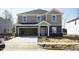 Two-story home with a gray exterior, attached garage, and unfinished landscaping in a new development at 3837 Rosebush Dr, Zebulon, NC 27597