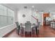 Bright dining area with wainscoting, hardwood floors and a view of the kitchen at 4108 Overcup Oak Ln, Cary, NC 27519