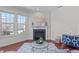 Living room boasts a fireplace, hardwood floors, and plentiful natural light at 4108 Overcup Oak Ln, Cary, NC 27519