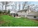 Wide backyard view of the home showing the patio, sunroom and grill at 4209 Converse Dr, Raleigh, NC 27609
