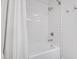 Clean white tub and tile in the updated bathroom creating a serene space at 4209 Converse Dr, Raleigh, NC 27609