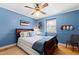 Cozy bedroom with blue walls, wood floors, and a ceiling fan, creating a relaxing atmosphere at 4209 Converse Dr, Raleigh, NC 27609
