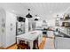 Spacious kitchen with island, stainless steel appliances, white cabinets, and modern lighting fixtures at 4209 Converse Dr, Raleigh, NC 27609