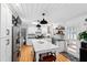 Modern kitchen with white cabinets, an island with seating, and lots of natural light at 4209 Converse Dr, Raleigh, NC 27609