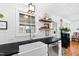 Kitchen features a white sink, dark countertops, stainless steel appliances, and natural lighting at 4209 Converse Dr, Raleigh, NC 27609