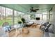 An expansive sunroom boasts wall-to-wall windows and a ceiling fan at 4209 Converse Dr, Raleigh, NC 27609