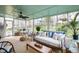 This sunroom has many windows, a ceiling fan, furniture and decor at 4209 Converse Dr, Raleigh, NC 27609