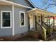 Side view of a gray two-story house featuring white trim, large windows, and brick foundation at 425 S Mercer St, Rocky Mount, NC 27801
