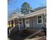 Covered porch featuring aged columns and white trim on a charming two-story home at 425 S Mercer St, Rocky Mount, NC 27801