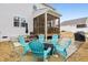 Inviting backyard patio with blue Adirondack chairs and a screened-in porch, perfect for outdoor relaxation at 440 Pierce Landing Dr, Garner, NC 27529